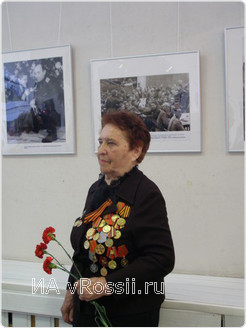 Мария Шаболовская на фоне работы, принесшей ей победу в фотоконкурсе
